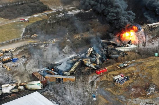 Debris from a Norfolk Southern freight train lies scattered and burning along the tracks on Feb. 4, 2023, the day after it derailed in East Palestine, Ohio.