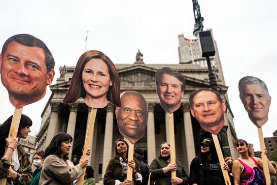 Demonstrators hold cutouts of U.S. Supreme Court Justices Tuesday at Foley Square in New York to protest the court’s draft opinion that would overturn Roe v Wade.