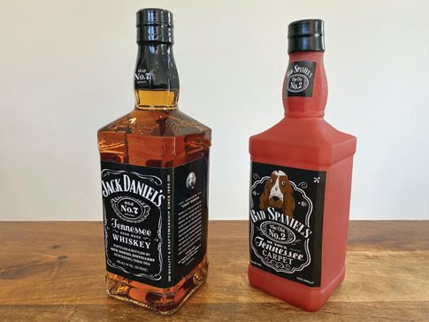 A bottle of Jack Daniel’s Tennessee Whiskey is displayed next to a Bad Spaniels dog toy. The Supreme Court heard a trademark dispute Wednesday between Jack Daniel’s and the manufacturer of the squeaking toy that parodies the liquor bottle.