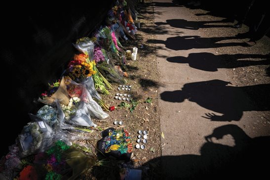 Visitors cast shadows at a memorial to the victims of the Astroworld concert in Houston in 2021.