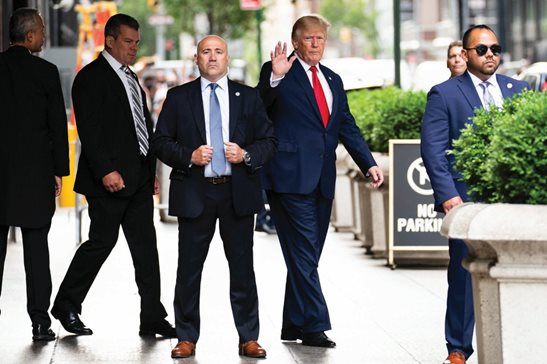 Former President Donald Trump waves as he departs Trump Tower Wednesday in New York on his way to the New York attorney general’s office for the deposition.