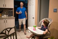 Dan McDowell carries water to his refrigerator as his 16-month-old daughter Caroline, looks on at their home in Horsham, Pa., on Aug. 1. In Horsham and surrounding towns in eastern Pennsylvania, and at other sites around the United States, the foams once used routinely in firefighting training at military bases contained per- and polyfluoroalkyl substances, or PFAS. EPA testing between 2013 and 2015 found significant amounts of PFAS in public water supplies in 33 U.S. states.