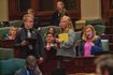 State Rep. Anna Moeller (right), D-Elgin, speaks on the House floor during debate on her bill to enact several reforms to the state’s insurance industry. The bill is an initiative of Gov. JB Pritzker, who is seated behind Moeller. The measure passed with bipartisan support.
