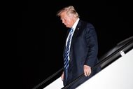 President Donald Trump steps off Air Force One as he arrives at Andrews Air Force Base in Maryland Tuesday night.