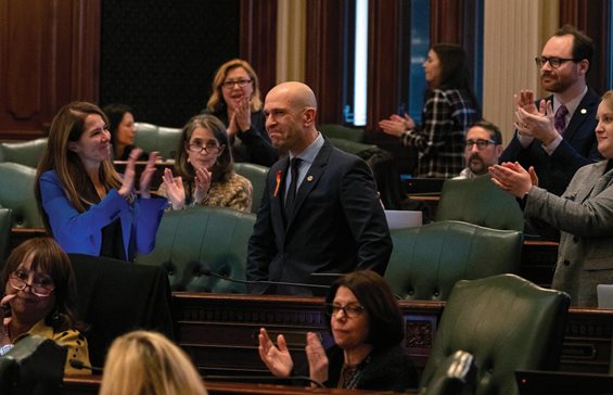 Colleagues applaud Illinois state Rep. Bob Morgan after passage of a bill banning assault weapons and high capacity magazines Tuesday at the Illinois State Capitol in Springfield. Morgan, a bill sponsor, was present at the Highland Park mass parade shooting on July 4, 2022. After a busy “lame duck” session, a mix of incumbents and newly minted lawmakers were sworn into their terms in the 103rd General Assembly Wednesday.